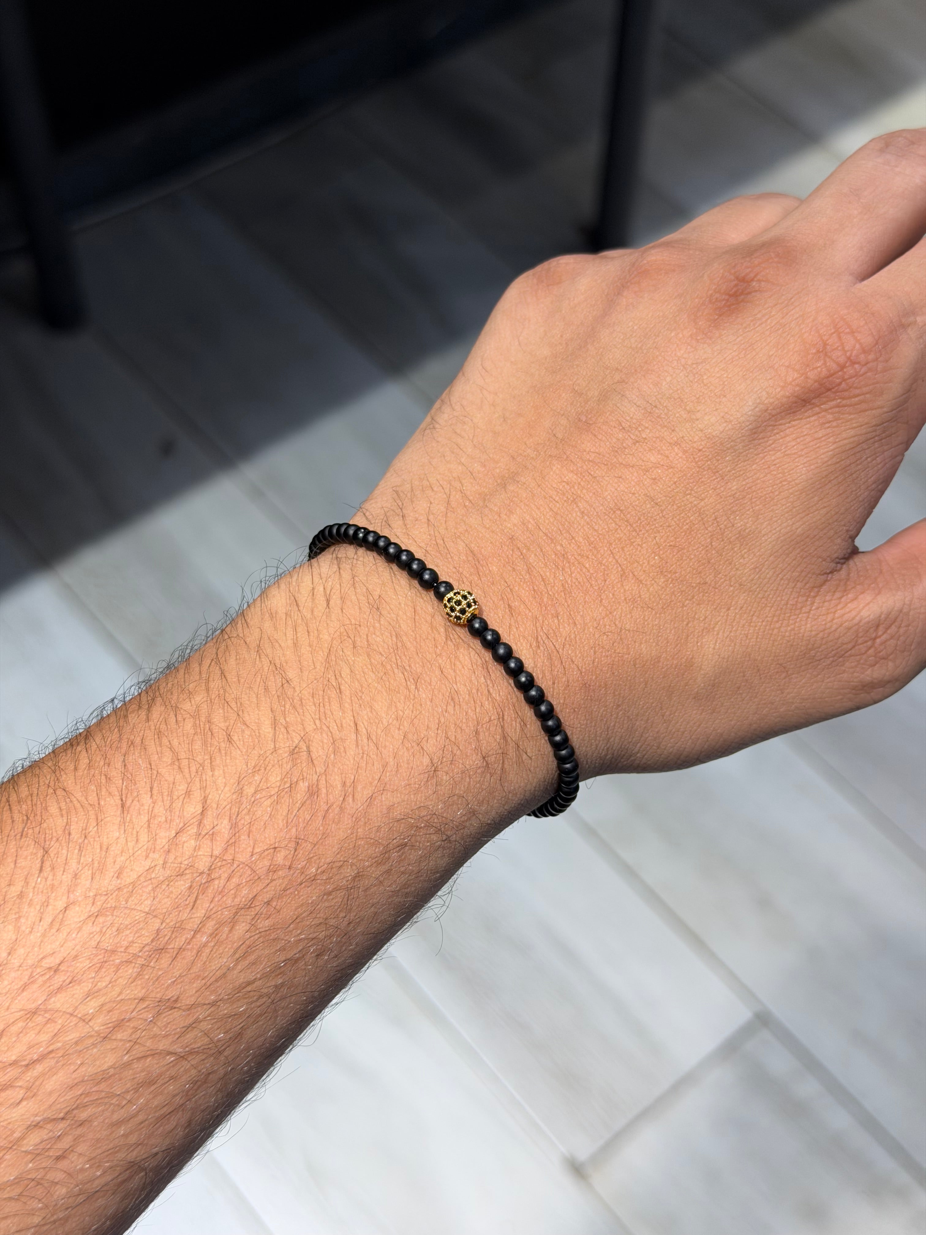 Onyx bracelet with gold zircon