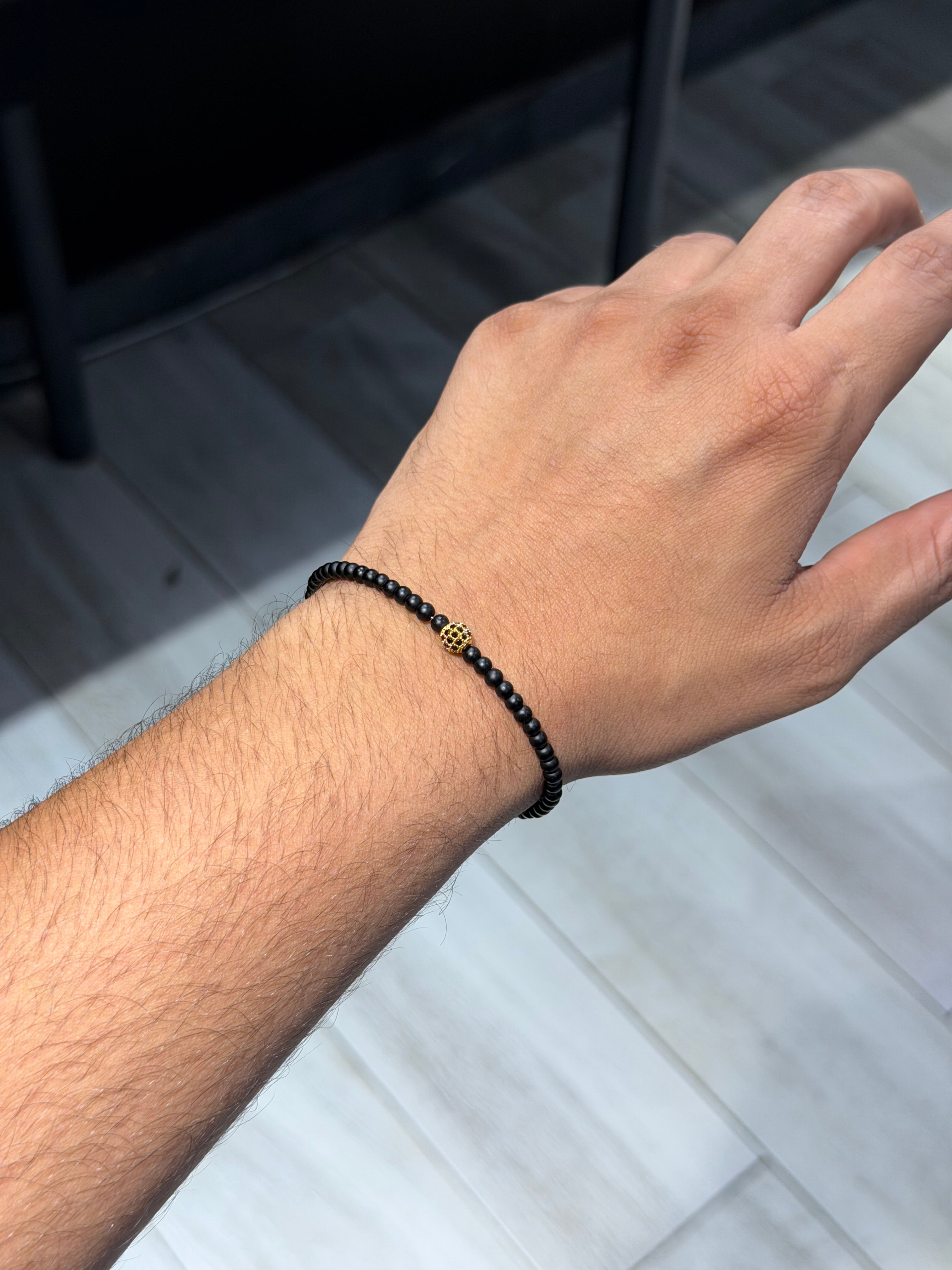 Onyx bracelet with gold zircon