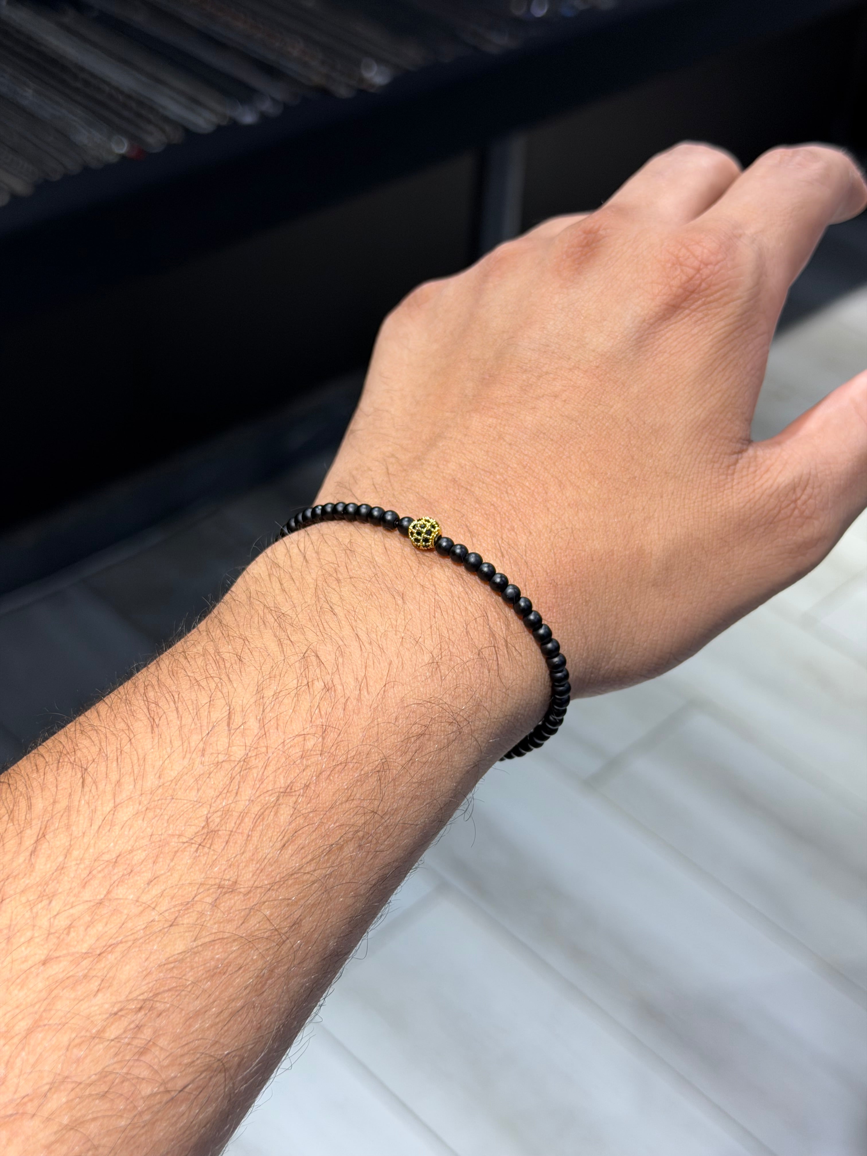 Onyx bracelet with gold zircon